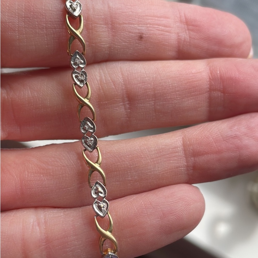 Gold bracelet with small diamonds in each heart